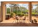 Screened lanai with seating and views of the landscaped backyard at 723 Oakwater Ln, Port Orange, FL 32128