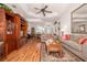 Open living room with wood flooring, tray ceiling, comfortable seating, and decorative accents at 723 Oakwater Ln, Port Orange, FL 32128