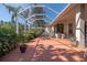 Screened-in patio featuring a fountain and outdoor furniture surrounded by lush landscaping at 723 Oakwater Ln, Port Orange, FL 32128