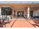 Screened-in patio featuring a fan and outdoor furniture surrounded by lush landscaping at 723 Oakwater Ln, Port Orange, FL 32128