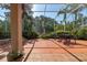 Screened-in patio featuring a fountain and outdoor furniture surrounded by lush landscaping at 723 Oakwater Ln, Port Orange, FL 32128