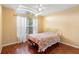 Comfortable bedroom featuring a double bed, wood flooring, and lots of light from window at 809 Brightview Dr, Lake Mary, FL 32746