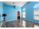 Spacious bedroom featuring blue walls, tile flooring, and a view into the bathroom at 809 Brightview Dr, Lake Mary, FL 32746