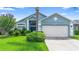 Charming single-story home features a manicured lawn, flowering trees, and an attached two-car garage at 809 Brightview Dr, Lake Mary, FL 32746