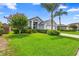 Well-maintained single-story home features a lush green lawn, mature trees, and an attached garage at 809 Brightview Dr, Lake Mary, FL 32746