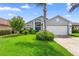 Charming single-story home features a manicured lawn, flowering trees, and an attached two-car garage at 809 Brightview Dr, Lake Mary, FL 32746