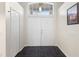 Foyer with double doors, marble tile floor, coat closet, and transom window at 809 Brightview Dr, Lake Mary, FL 32746