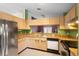 Well-lit kitchen with stainless steel appliances, modern cabinetry, and breakfast bar at 809 Brightview Dr, Lake Mary, FL 32746