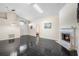Open living room boasts fireplace, arched entryway, and modern black tile flooring at 809 Brightview Dr, Lake Mary, FL 32746