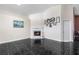 Bright living room featuring a fireplace, high ceilings, and modern black tile flooring at 809 Brightview Dr, Lake Mary, FL 32746