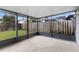 Spacious screened patio with gray trim, concrete floor, and view of the backyard at 809 Brightview Dr, Lake Mary, FL 32746