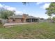 Brick home featuring a spacious backyard, wood deck, and healthy lawn at 901 Vicksburg St, Deltona, FL 32725