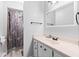 Clean bathroom with a shower and a long vanity sink next to a mirror at 901 Vicksburg St, Deltona, FL 32725
