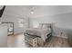 Spacious bedroom features a ceiling fan, a large window, and wood-look flooring at 901 Vicksburg St, Deltona, FL 32725