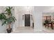 Welcoming entryway with wood-look floors, a modern light fixture, and a view of the dining area at 901 Vicksburg St, Deltona, FL 32725
