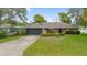 Charming home with a well-manicured front lawn and attached garage at 901 Vicksburg St, Deltona, FL 32725
