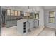 Well-appointed kitchen with gray cabinets, a bar-style island, and stainless steel appliances at 901 Vicksburg St, Deltona, FL 32725