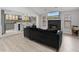 Stylish living room featuring fireplace, seamless flow to kitchen, and contemporary furnishings at 901 Vicksburg St, Deltona, FL 32725