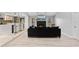Open-concept living room featuring hardwood floors, a fireplace, and seamless kitchen access at 901 Vicksburg St, Deltona, FL 32725