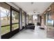 View of cozy sunroom with tile flooring, neutral paint, and backyard view at 901 Vicksburg St, Deltona, FL 32725