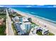 Stunning aerial view of beachfront property with pristine sands, a refreshing pool, and convenient parking at 915 Ocean Shore Blvd # 8010, Ormond Beach, FL 32176
