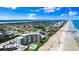 Beautiful aerial view showcasing beachfront condos with lush landscaping and a sparkling pool, perfect for coastal living at 915 Ocean Shore Blvd # 8010, Ormond Beach, FL 32176