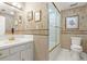 A well appointed bathroom with a walk-in shower, toilet, and a neutral color scheme at 915 Ocean Shore Blvd # 8010, Ormond Beach, FL 32176