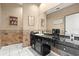 Well-maintained bathroom featuring a vanity with black countertop and backsplash at 915 Ocean Shore Blvd # 8010, Ormond Beach, FL 32176