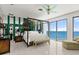 Bedroom featuring view of the ocean, tiled floors, and a four-poster bed at 915 Ocean Shore Blvd # 8010, Ormond Beach, FL 32176