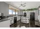 Charming black and white kitchen with modern appliances and a large sink overlooking water views at 915 Ocean Shore Blvd # 8010, Ormond Beach, FL 32176