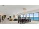 Expansive living room and dining area with floor-to-ceiling windows and stunning ocean views at 915 Ocean Shore Blvd # 8010, Ormond Beach, FL 32176