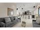 Open concept living room with bar area, tile floors, neutral paint and comfortable grey sofas at 915 Ocean Shore Blvd # 8010, Ormond Beach, FL 32176