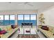 Bright living room with tile floors and large windows showcasing ocean views at 915 Ocean Shore Blvd # 8010, Ormond Beach, FL 32176