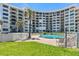 Resort-style pool surrounded by lush landscaping and lounging area in front of the condo building at 915 Ocean Shore Blvd # 8010, Ormond Beach, FL 32176