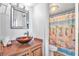 A cozy bathroom with a stylish vessel sink and a shower with a palm tree themed curtain at 935 S Atlantic Ave # 505, Daytona Beach, FL 32118