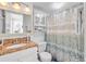A functional bathroom with a granite countertop vanity and shower with a stylish curtain at 935 S Atlantic Ave # 505, Daytona Beach, FL 32118