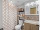 Cozy bathroom features a tile shower with patterned curtain, granite vanity, and ample storage space at 935 S Atlantic Ave # 511, Daytona Beach, FL 32118