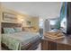 Relaxing bedroom features a bed, comfortable daybed, and view of the ocean from the window at 935 S Atlantic Ave # 511, Daytona Beach, FL 32118