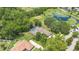 Expansive aerial view showcasing the house, screened pool, pond, and surrounding greenery at 980 Marjorie Rawlings Dr, Deland, FL 32720