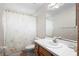 Well-lit bathroom with a shower and vanity, decorated with patterned wallpaper at 980 Marjorie Rawlings Dr, Deland, FL 32720