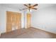 This bedroom offers a ceiling fan and natural light, complemented by a large closet at 980 Marjorie Rawlings Dr, Deland, FL 32720