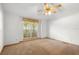 Bright bedroom with a ceiling fan and large window, providing ample natural light at 980 Marjorie Rawlings Dr, Deland, FL 32720