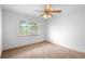 This bedroom includes a large window and ceiling fan, offering natural light at 980 Marjorie Rawlings Dr, Deland, FL 32720