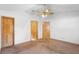 Large bedroom features multiple doors and ceiling fan at 980 Marjorie Rawlings Dr, Deland, FL 32720