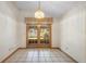 Sunny dining room boasts french doors to the screened porch and outdoor living spaces at 980 Marjorie Rawlings Dr, Deland, FL 32720