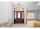 Bright foyer featuring a decorative chandelier, tile flooring and adjacent living spaces at 980 Marjorie Rawlings Dr, Deland, FL 32720
