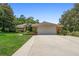 Charming single-story brick home with a spacious two-car garage and well-manicured lawn at 980 Marjorie Rawlings Dr, Deland, FL 32720
