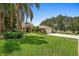 Beautiful brick home featuring mature trees, landscaping and a well-maintained lawn at 980 Marjorie Rawlings Dr, Deland, FL 32720