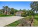 Detached garage with a wide driveway and green lawn, offering ample parking and curb appeal at 980 Marjorie Rawlings Dr, Deland, FL 32720