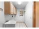 Bright laundry room with a utility sink, cabinets, and a window for natural light at 980 Marjorie Rawlings Dr, Deland, FL 32720